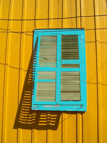Sharon Wells Blue Shutter, Yellow Wall Tile